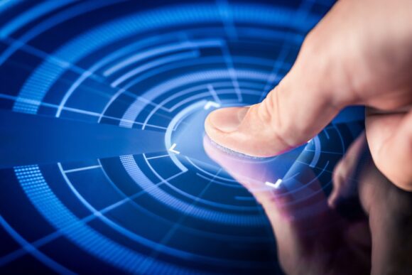 A thumb pressed against a blue screen being analyzed by a fingerprint scanner